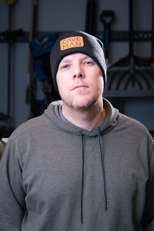 Man wearing Black Cave Man beanie apparel
