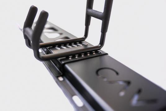 Close-up of a black metal bracket with 'Sav' branding on a light gray background